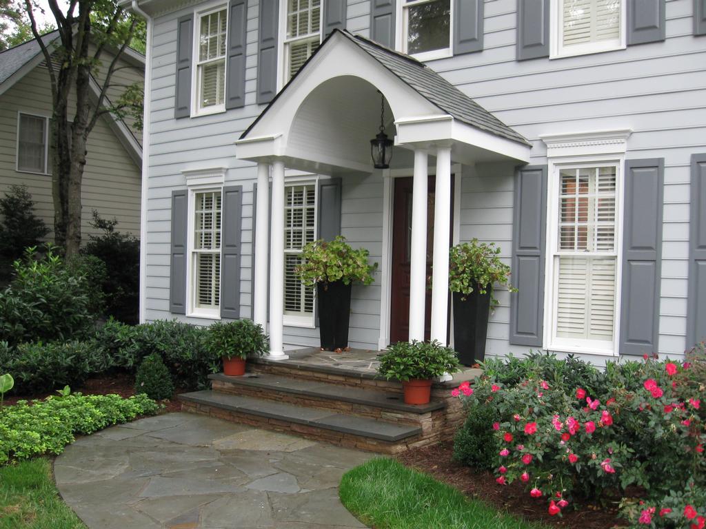 Irregular bluestone paving leads to redesigned front stoop from Linden